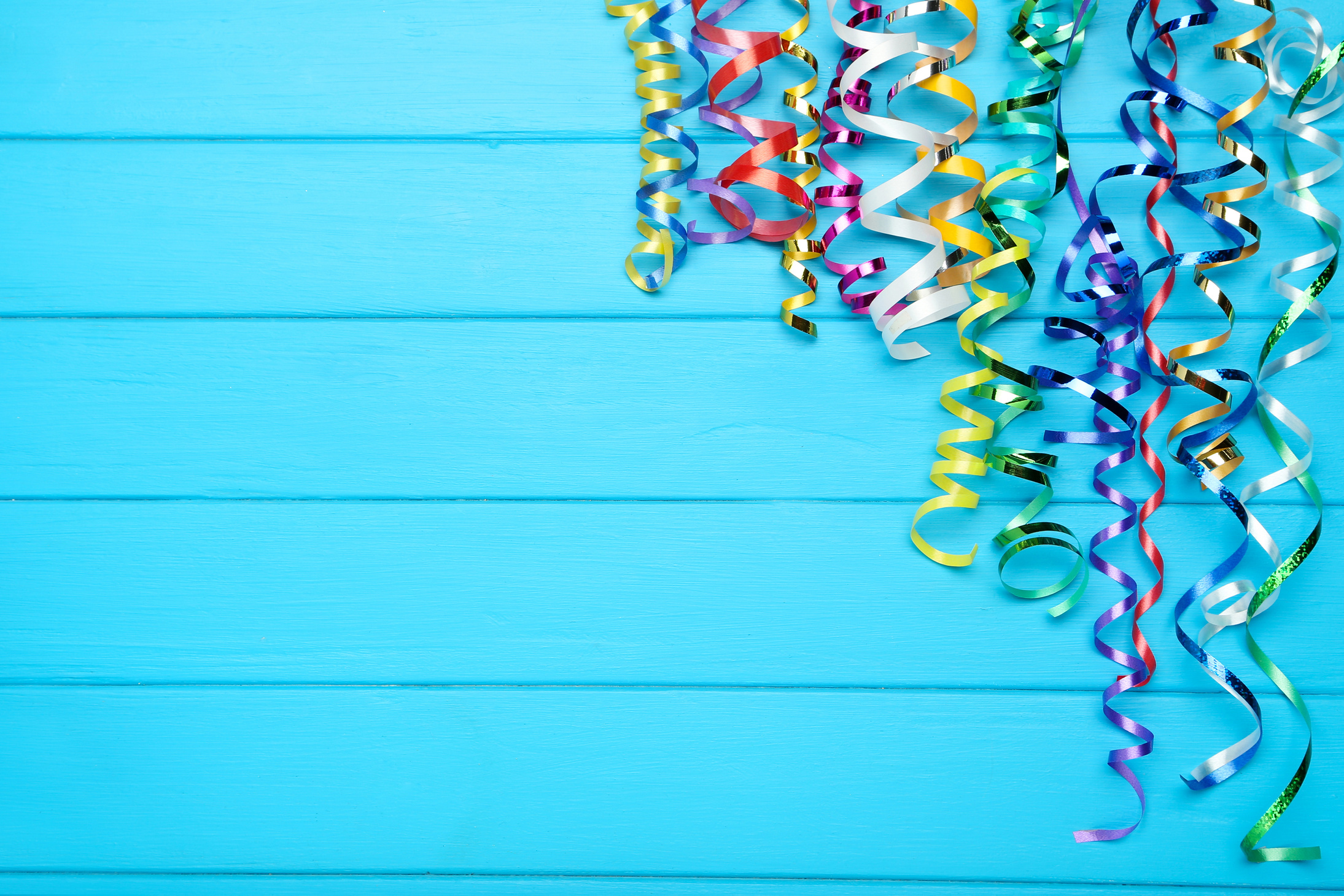 Colorful ribbons on blue wooden background